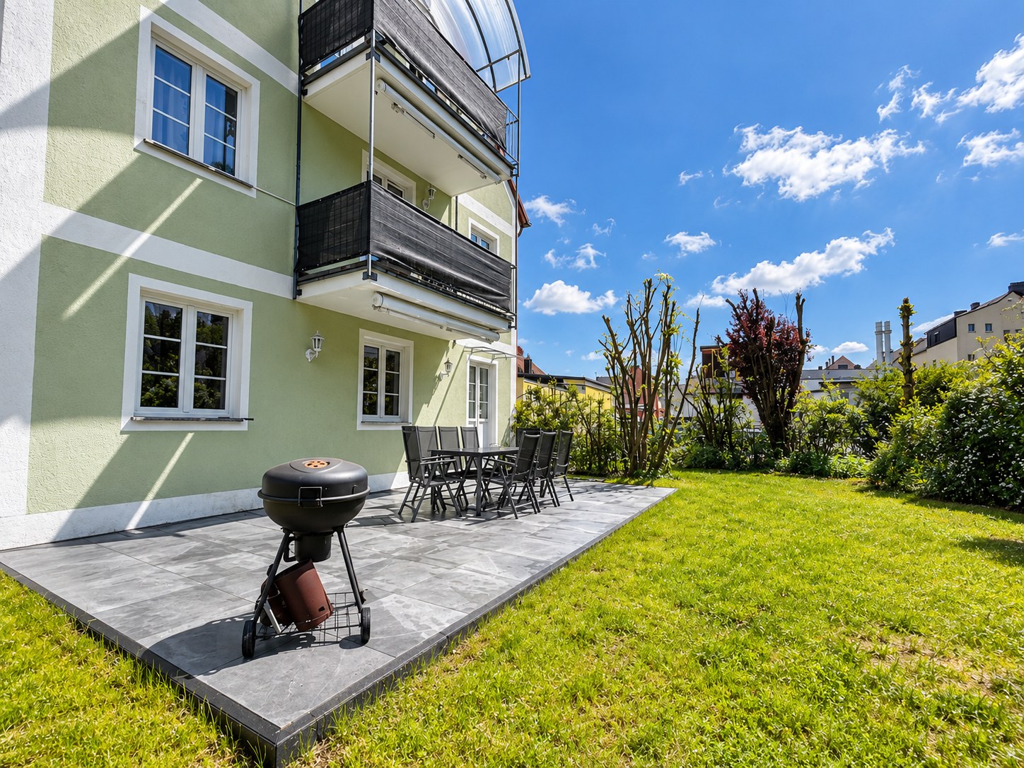 Garten mit Rasenfläche und Sitzplatz an der Terrasse